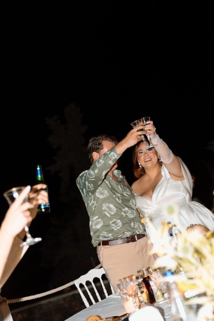 bride and groom toast at night reception