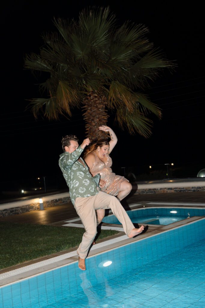 bride and groom jump into a pool at the end of the reception 